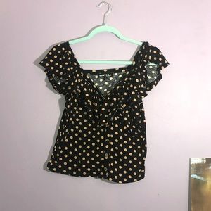 Ruffled V-neck polka dot top.